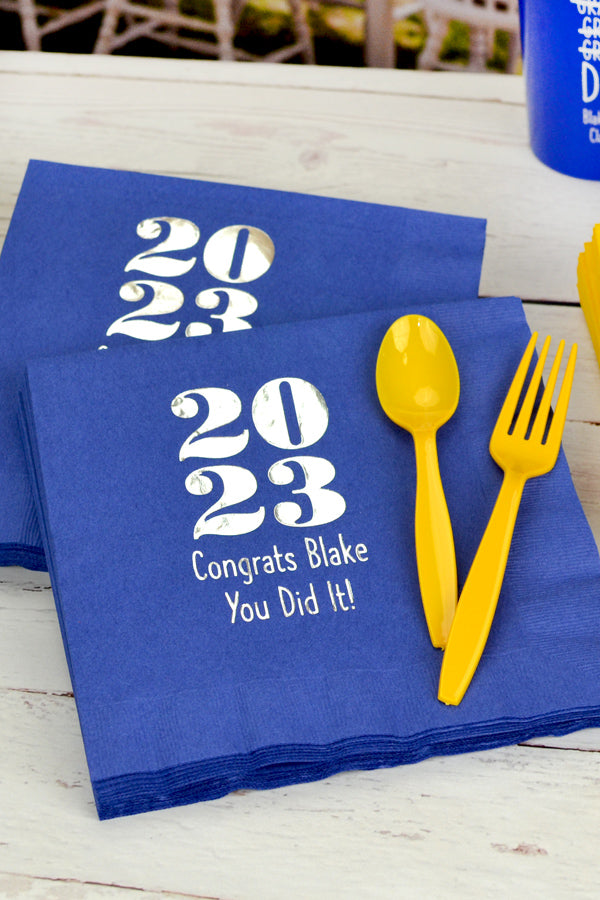 blue graduation luncheon napkins personalized with class year design and text in white print