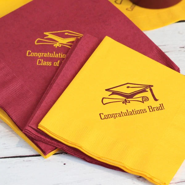 yellow, burgundy gradautiona beverage, luncheon napkins personalized with graduatoin cap design and text in burgundy, yellow print