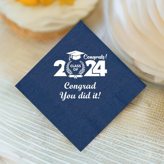 navy beverage napkin personalized for graduation party with clas of 2024 modern design and custom text in white print