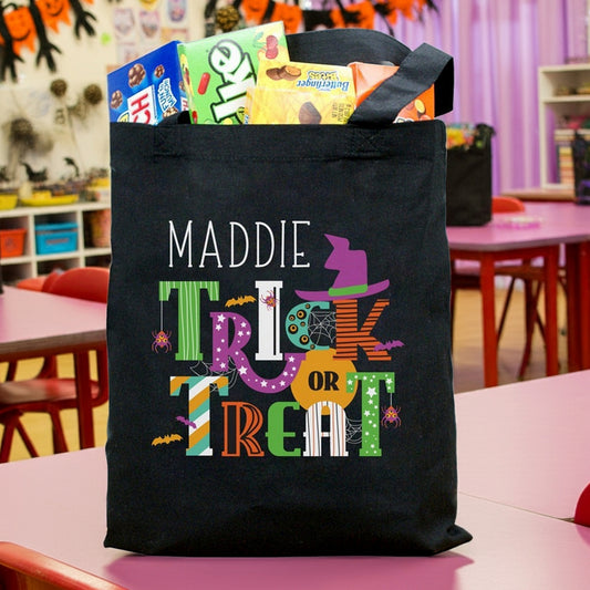 Black canvas Trick Or Treat tote with name Maddie and colorful Halloween graphics with candy personalized halloween candy bag