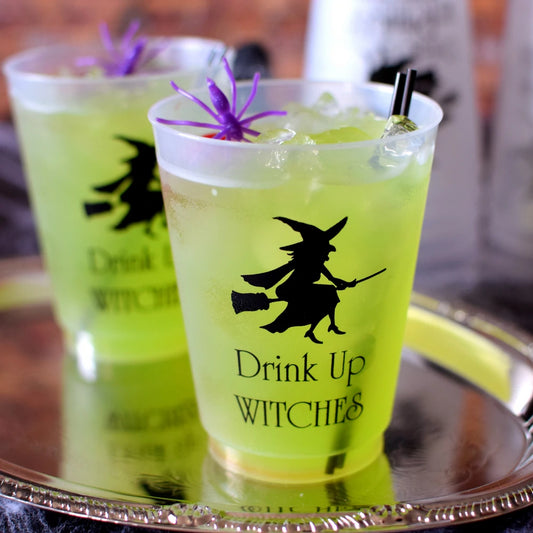 Tippytoad personalized halloween cups with black witch design filled with green drink and decorated with purple spider