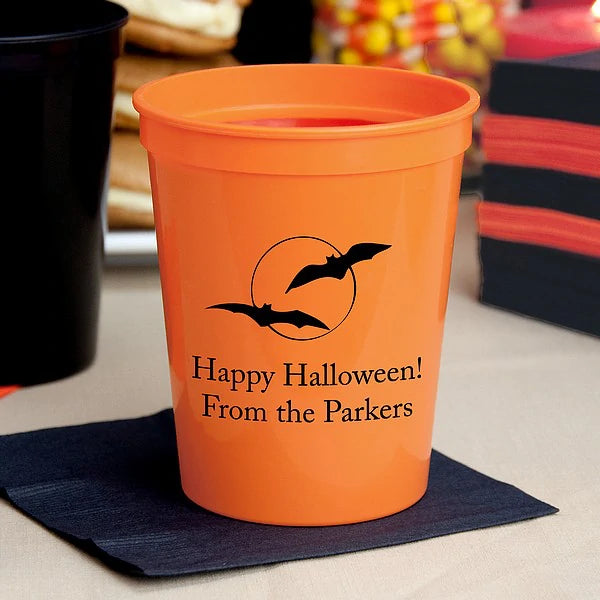 Orange 16 oz. halloween stadium cup personalized with bats and moon design and custom text in black print
