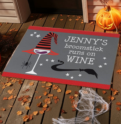 Personalized halloween doormat with witch hat, wine glass, spider, and broomstick design on porch