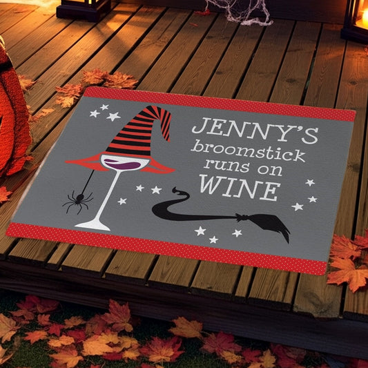 Personalized halloween doormat with witch hat, spider, and text Jenny's broomstick runs on wine