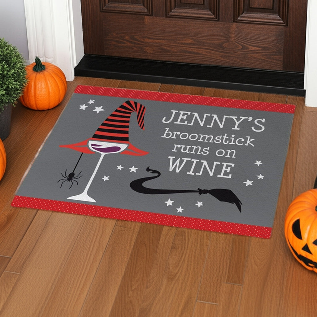 Personalized halloween doormat with witch hat, spider, wine glass, and text Jenny's broomstick runs on wine