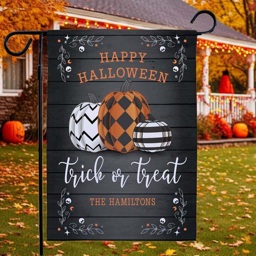 Custom Halloween garden flag personalized with three patterned pumpkins trick or treat design and family name