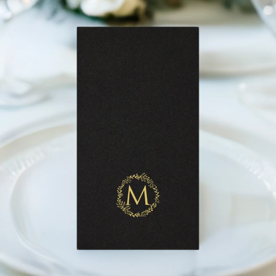 black color linen look guest hand towel personalized with ivory wreath initial M on wedding dinner plate