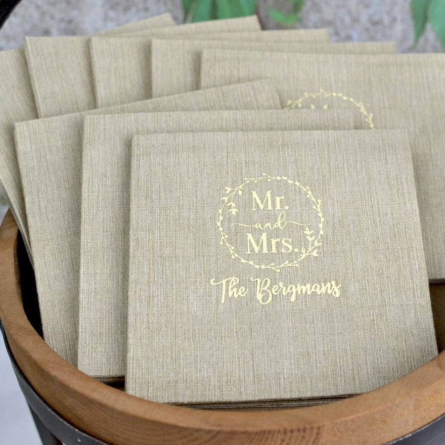 Taupe color eco-sustainable bamboo fiber wedding beverage napkins custom printed with mr and mrs wreath design and married name in ivory print