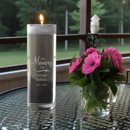 Personalized memorial candle vase with In Memory of George Keller engraving next to pink flowers