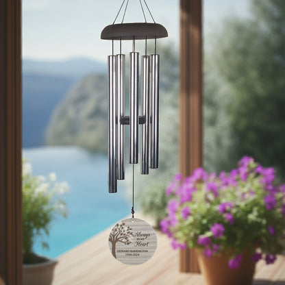 Personalized memorial wind chime hanging outdoors with engraved tribute and silver tubes