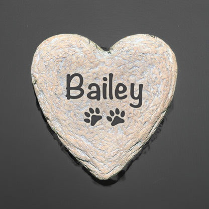 Heart-shaped personalized pet memorial stone with name Bailey and paw print design