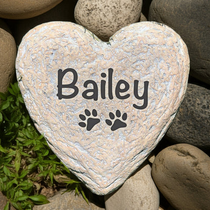Heart-shaped personalized pet memorial stone with paw prints and pet name Bailey