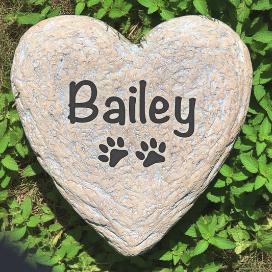 Heart-shaped garden stone with pet name and paw prints personalized pet memorial stone