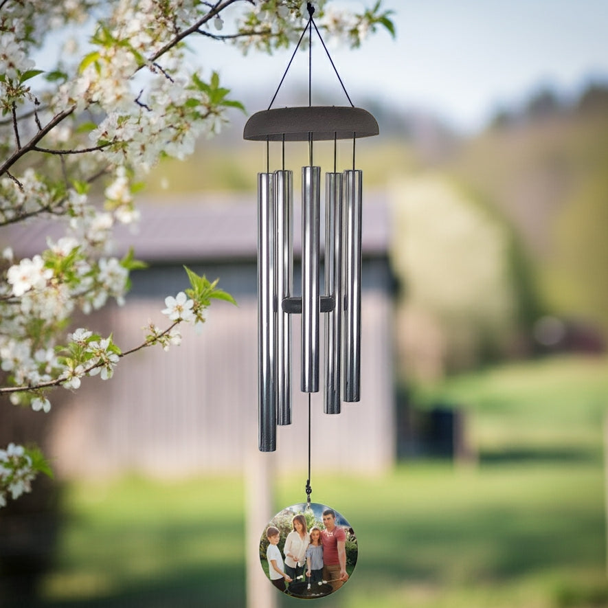 Personalized photo memorial wind chime with metal tubes and custom photo hanging outdoors in garden