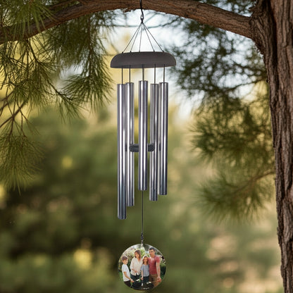 Personalized photo memorial wind chime hanging from tree branch with metal tubes and custom photo pendant