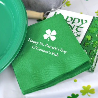 Green color saint patricks day cocktail napkins personalized with shamrock design and 2 lines of text in white print