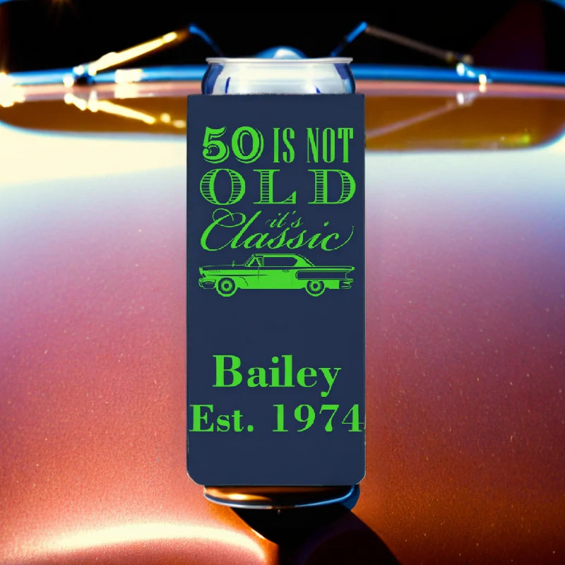 Navy color adult birthday slim can cooler personalized with 50 is not old classic car design and 2 lines of text in neon green print setting on classic car hood