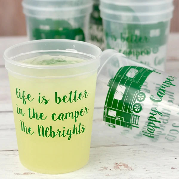 Clear color summer party stadium cups personalized with custom text on front side and camper design on back side in green print for camping