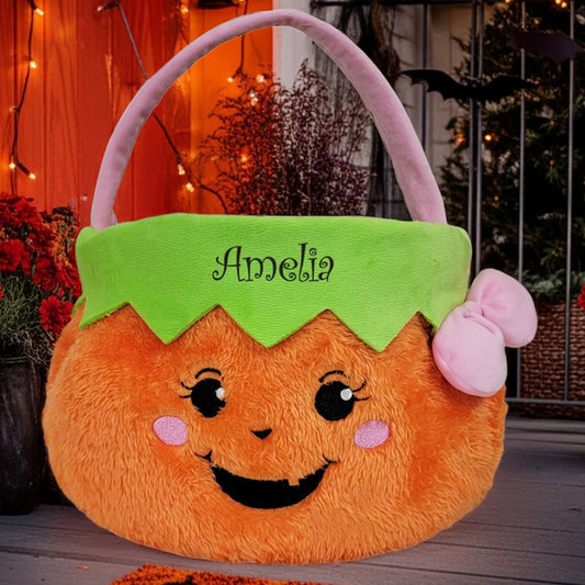 Personalized trick or treat basket in orange pumpkin design with green top and pink bow