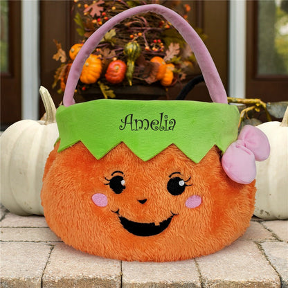 Personalized trick or treat basket in orange plush pumpkin design with green top and purple handle