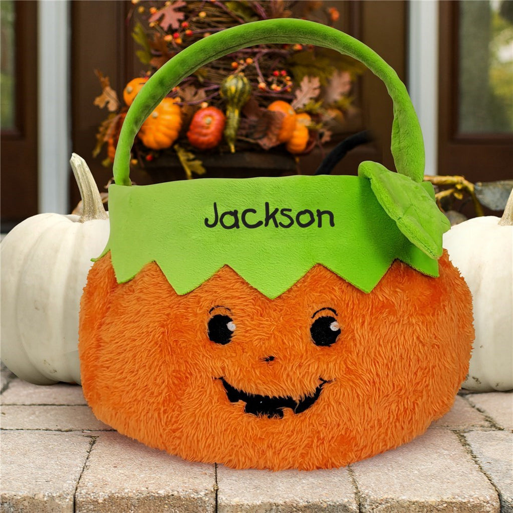 Personalized trick or treat candy basket in orange pumpkin design with green handle and name Jackson