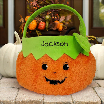 Personalized trick or treat candy basket in orange pumpkin design with green handle and name Jackson