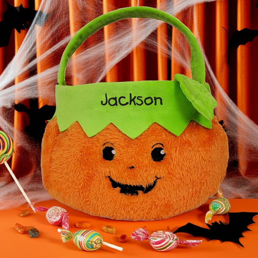 Personalized trick or treat candy basket shaped like a plush pumpkin with green handle and name Jackson