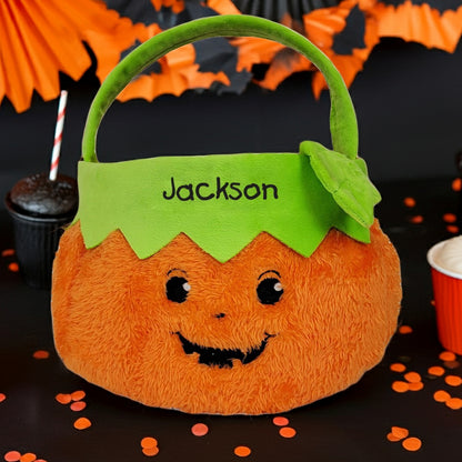 Personalized trick or treat candy basket in pumpkin shape with green handle and name Jackson