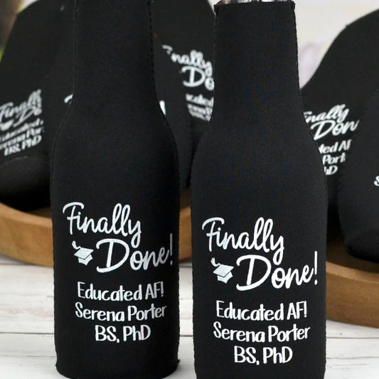 Black neoprene graduation bottle cooler sleeves personalized with finally done design and 3 lines of text in white print for college grad party