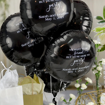 Black round mylar wedding balloons personalized with here to party design and custom text in white print