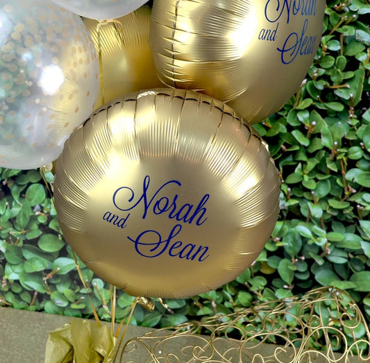 Luxe gold color Mylar balloons personalized for wedding with custom bride and groom monogram in navy print