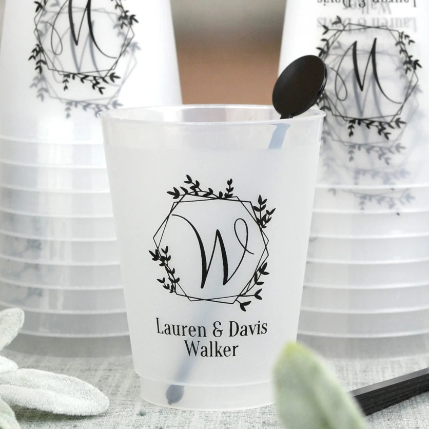 Clear frosted 16 ounce plastic wedding cups personalized with 'Geodesic Wreath Initial 'W' design with 2 lines of custom text in black imprint color