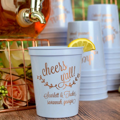 Personalized wedding cups in light blue with gold lettering and floral design for a festive celebration