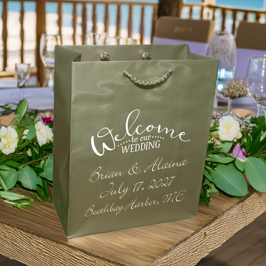 Tippytoad olive green wedding welcome bags custom printed with white script names and date on rope handle bag