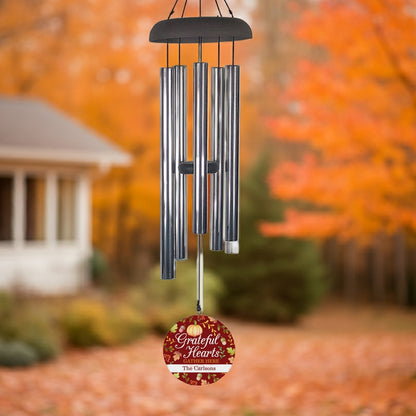 Personalized wind chime gift with metal tubes and custom engraved red hanging disc