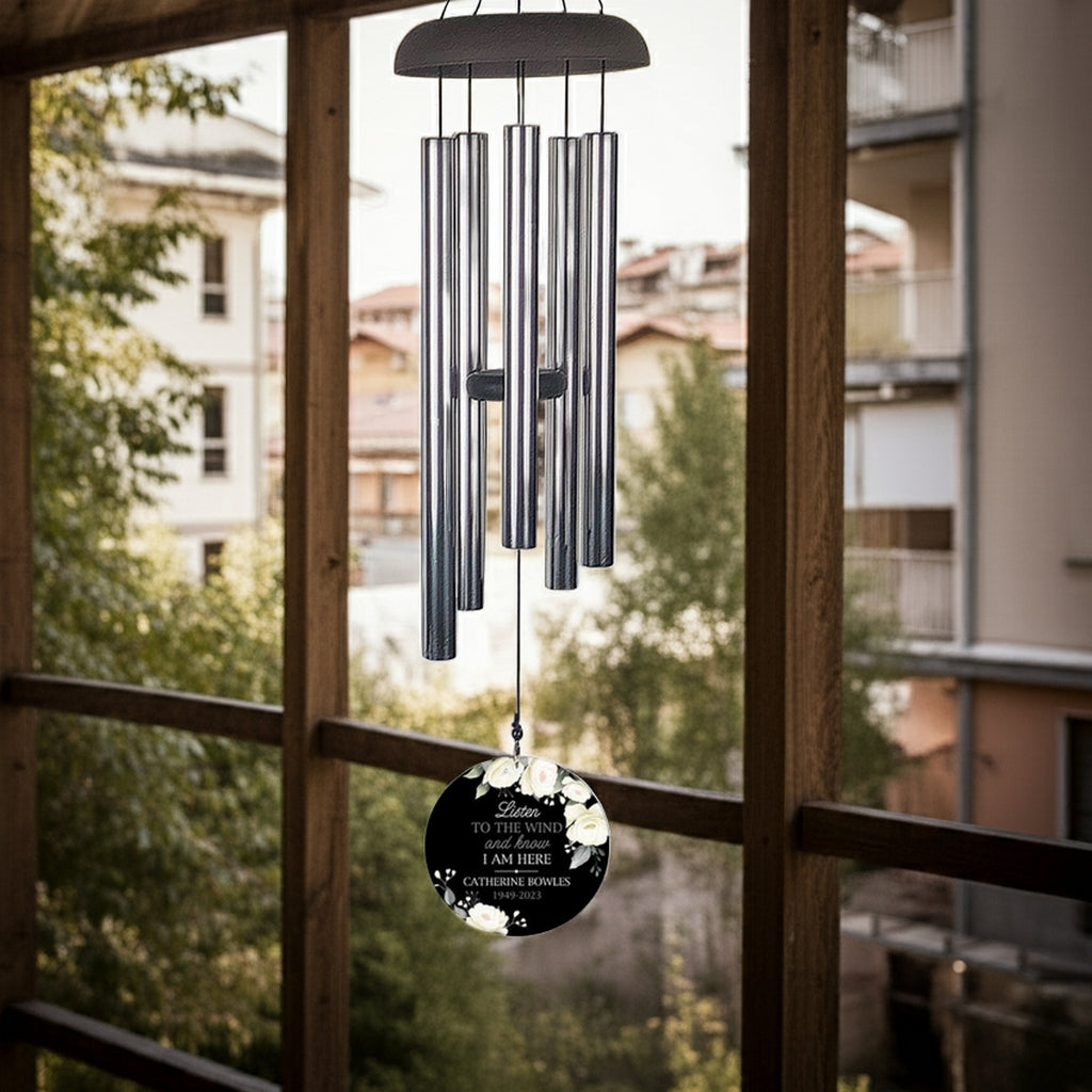 Personalized wind chime memorial hanging on porch with engraved message