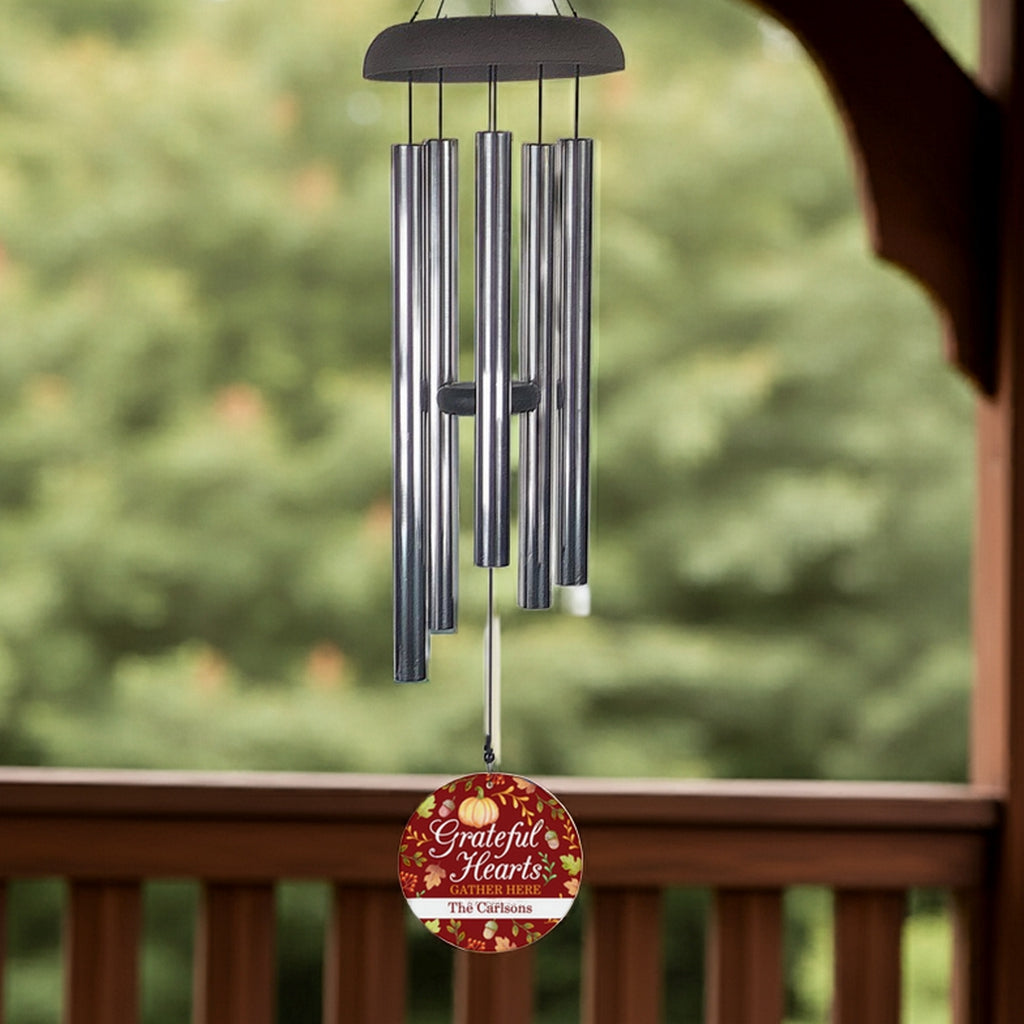 Personalized wind chime with grateful hearts design hanging outdoors