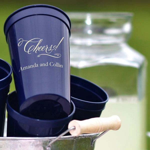 Navy 22 oz. stadium wedding cups personalized with cheers script design and bride and groom names in caramel print