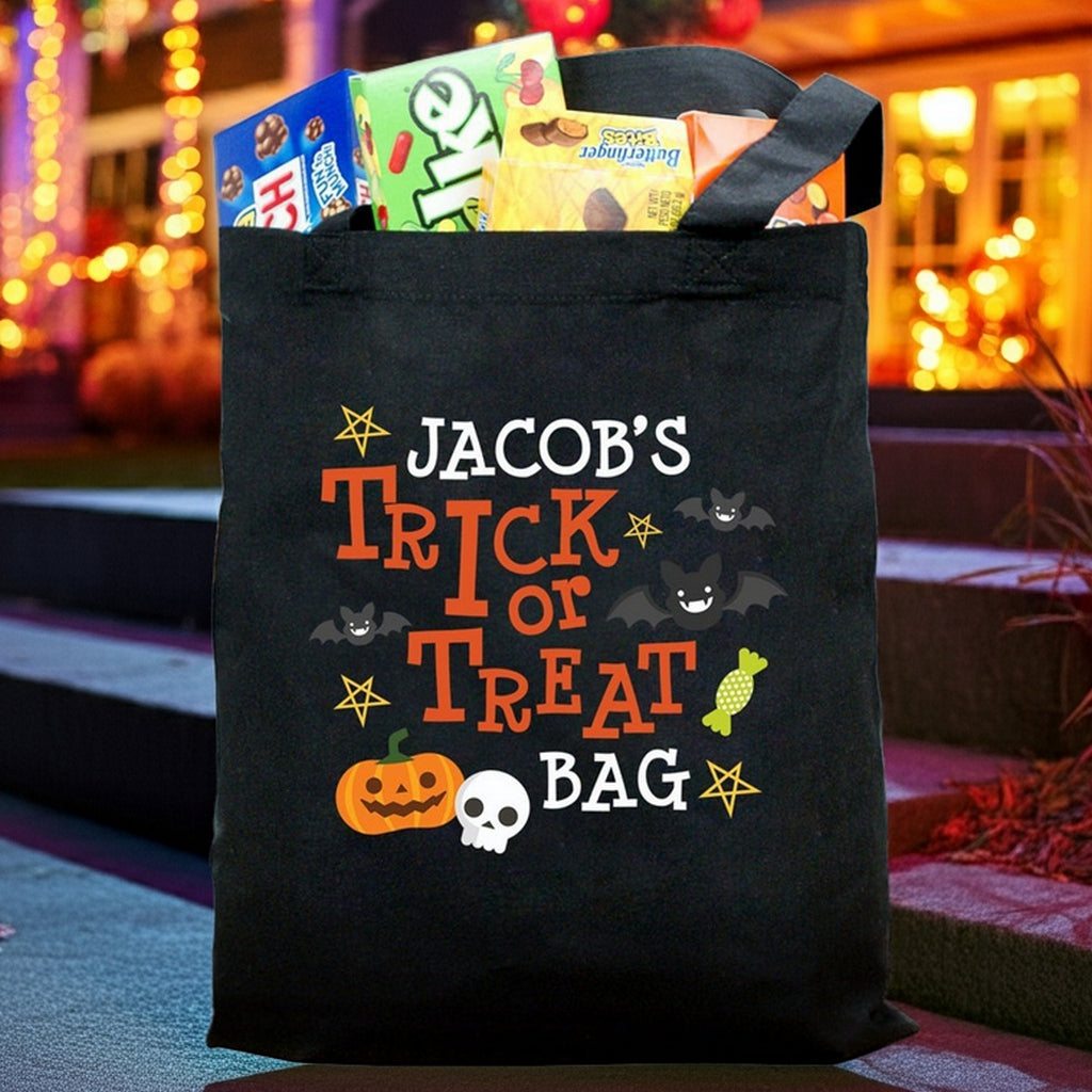 Black trick or treat bag filled with candy showing Jacobs Trick or Treat design with pumpkin skull and bats