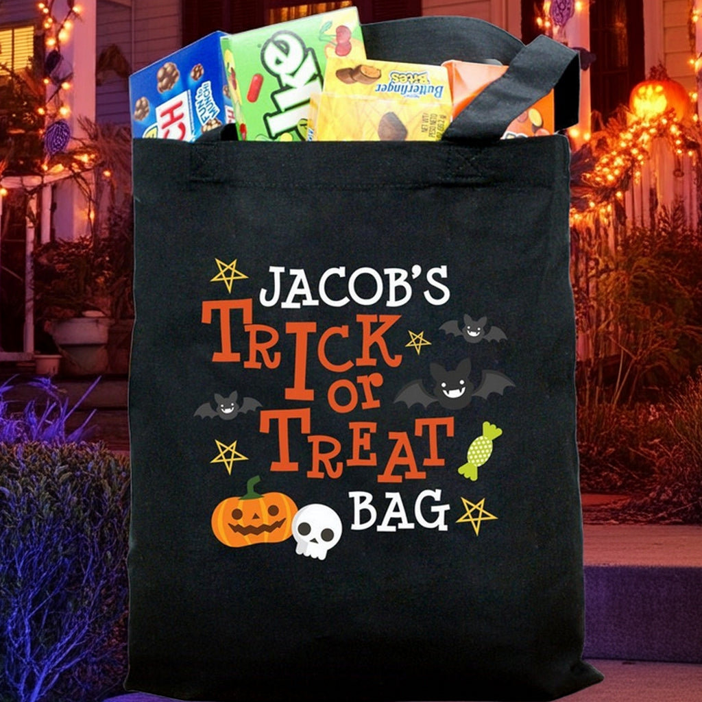 Black Halloween tote bag personalized with name Jacobs and pumpkin skull and bats personalized trick or treat bag graphic filled with candy