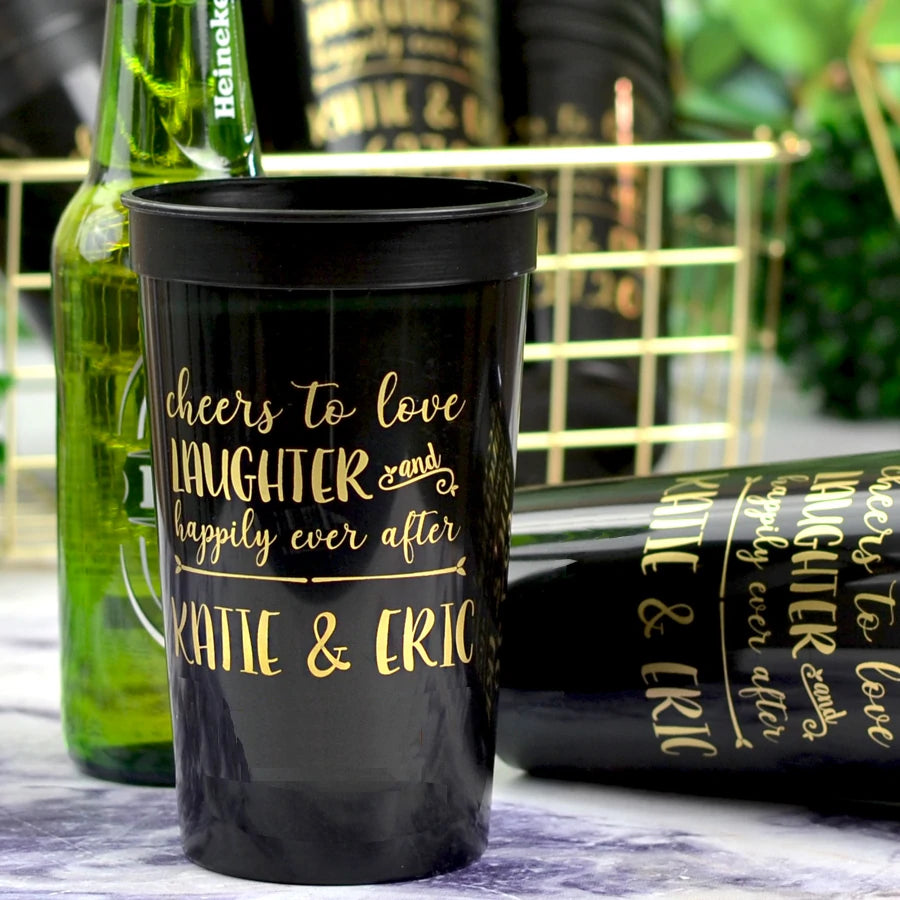 Black 22 oz. stadium wedding cups custom printed with happily ever after design and bride and groom names in gold print