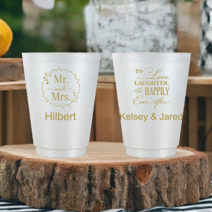 Rustic theme wedding reception cups personalized with mr and mrs wreath design and text on front side and happily ever after design with bride and groom name on back in gold print