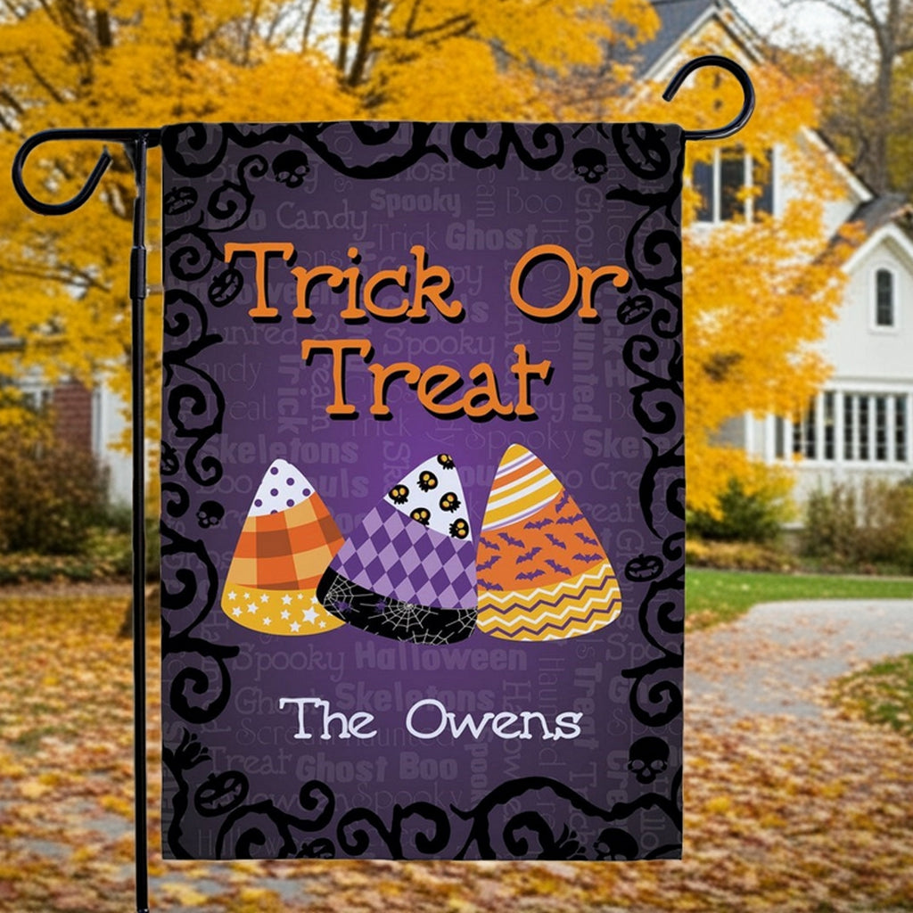 Halloween garden flag purple Trick Or Treat design with three decorated candy corns and personalized The Owens