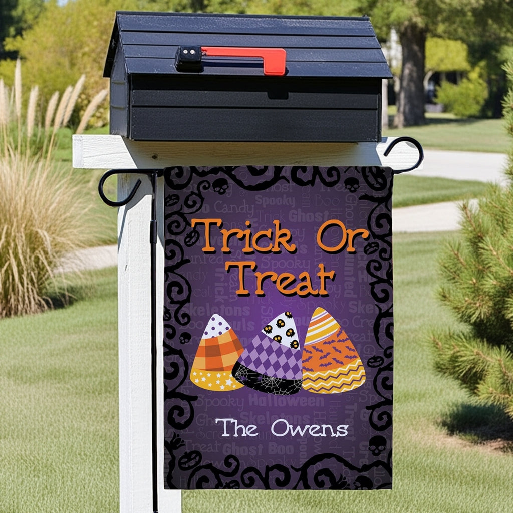 Halloween garden flag hanging on mailbox with Trick Or Treat candy corn design and personalized The Owens