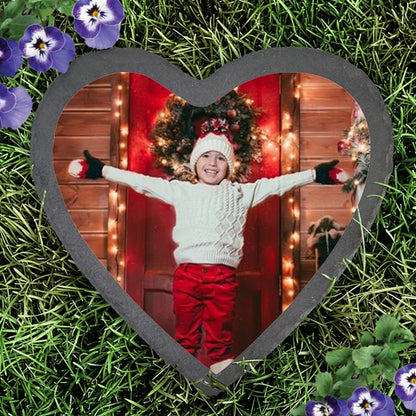 Slate heart photo garden stone featuring a child's holiday photo surrounded by grass and flowers