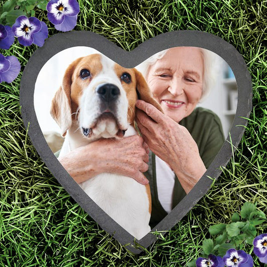 Slate heart photo garden stone featuring a heart-shaped stone with a photo of an elderly woman hugging a dog
