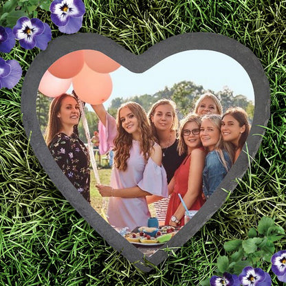 Slate heart photo garden stone displaying a group photo set on grass with purple flowers