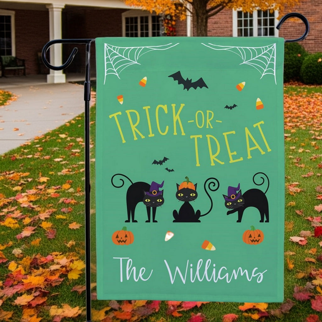 Halloween garden flag green with Trick or Treat text three black cats pumpkins candy corn personalized The Williams