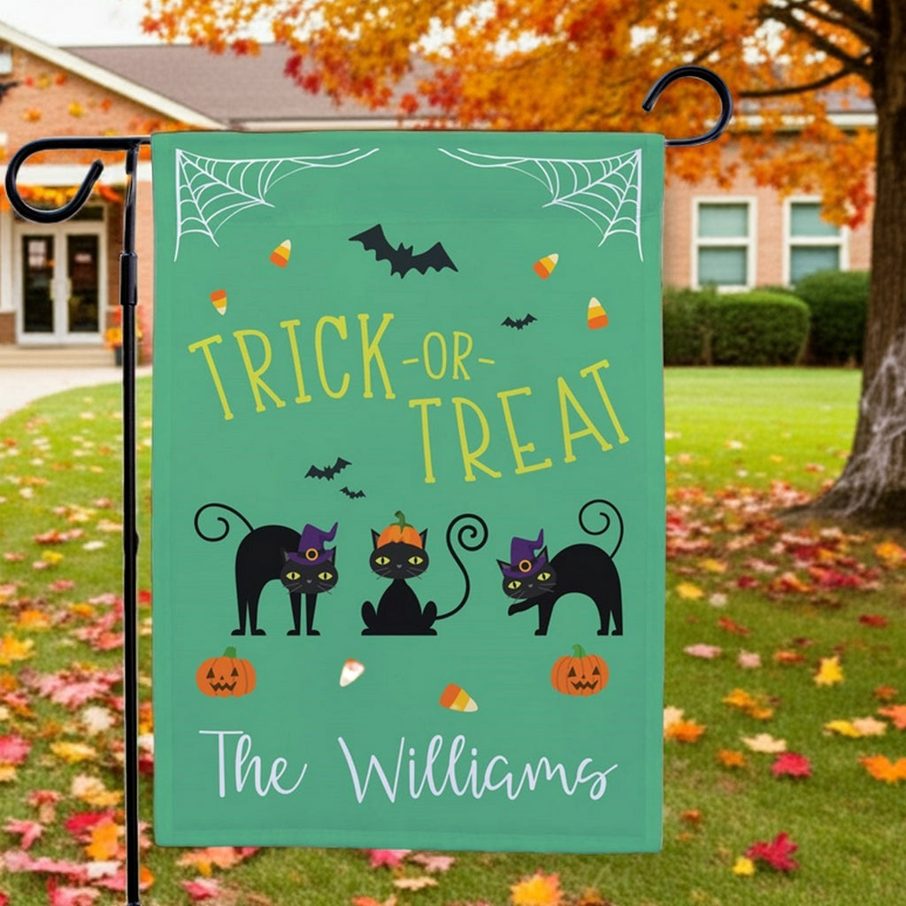 Halloween garden flag green Trick or Treat design with three black cats pumpkins and candy corn