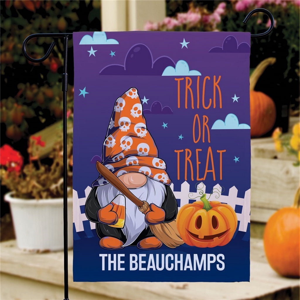 Halloween garden flag with gnome in skull hat holding broom and jack o lantern reads Trick Or Treat